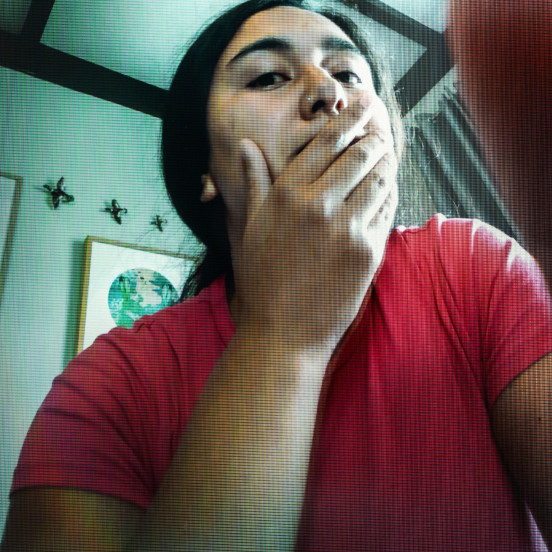 Photo of a woman in red resting her chin in her hand