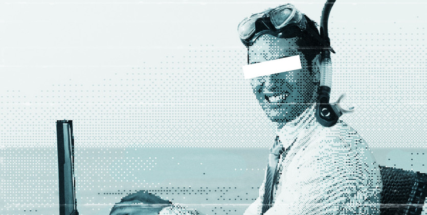 Grainy photo of a man sitting at his laptop in the sea with a snorkel and mask on