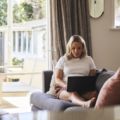 Woman on couch with laptop