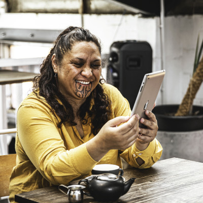 Māori woman holding device