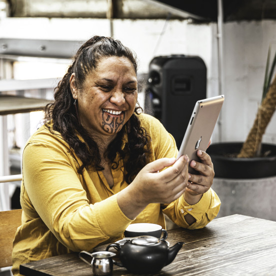 Māori woman holding device