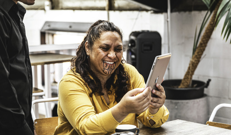 Māori woman holding device