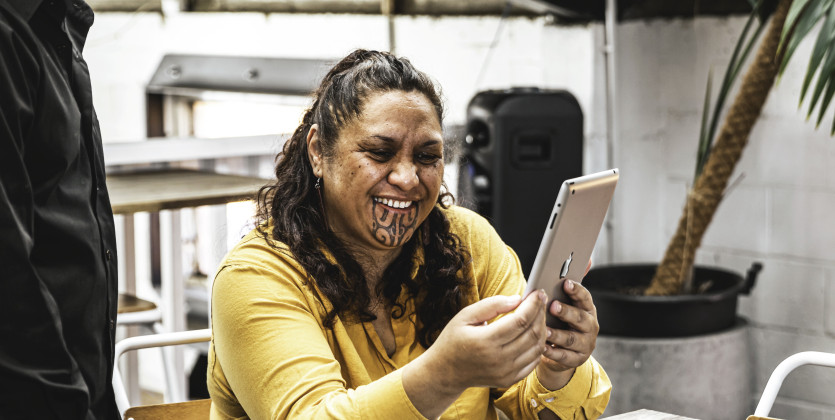 Māori woman holding device