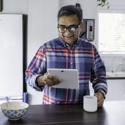 Man on his tablet and having a coffee