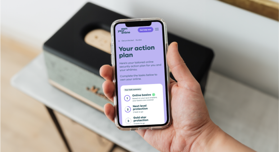 Photo of a man's hands holding a mobile phone with webpage showing the words Your action plan.