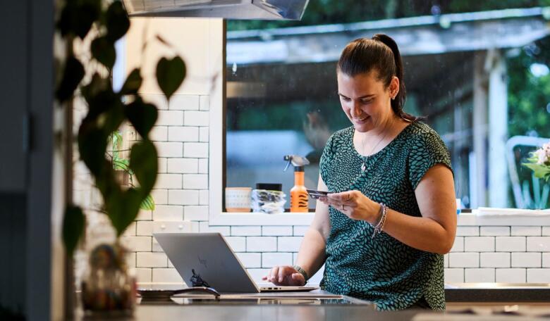 Woman on phone in kitchen