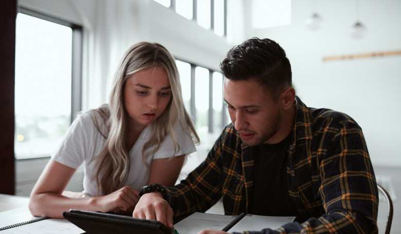 Man and woman looking at an Ipad