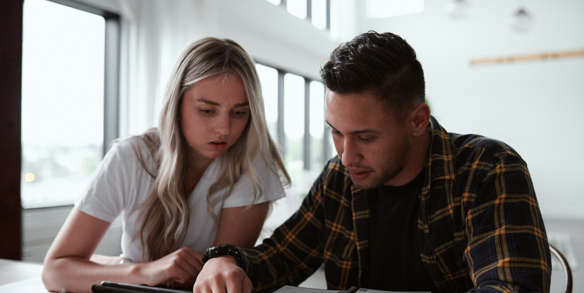 Man and woman looking at an Ipad