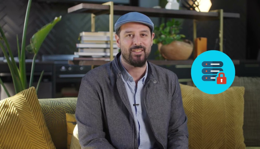Photo of a guy sitting on a couch wearing a cap